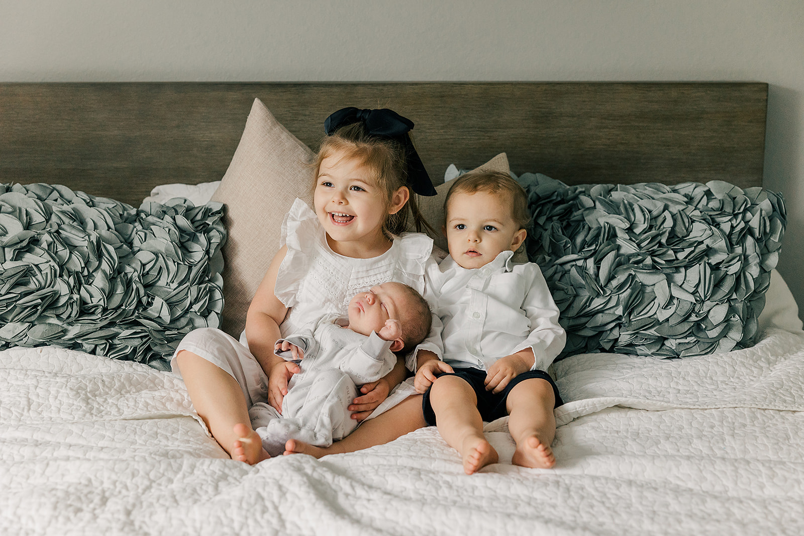 baby number three with toddler siblings