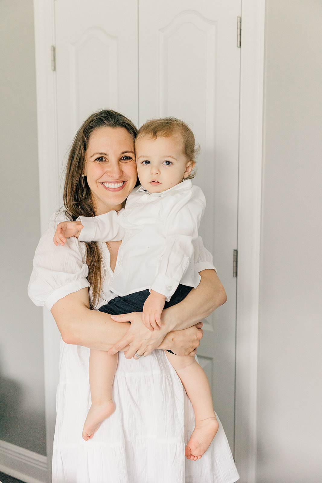 Mom and toddler boy in white