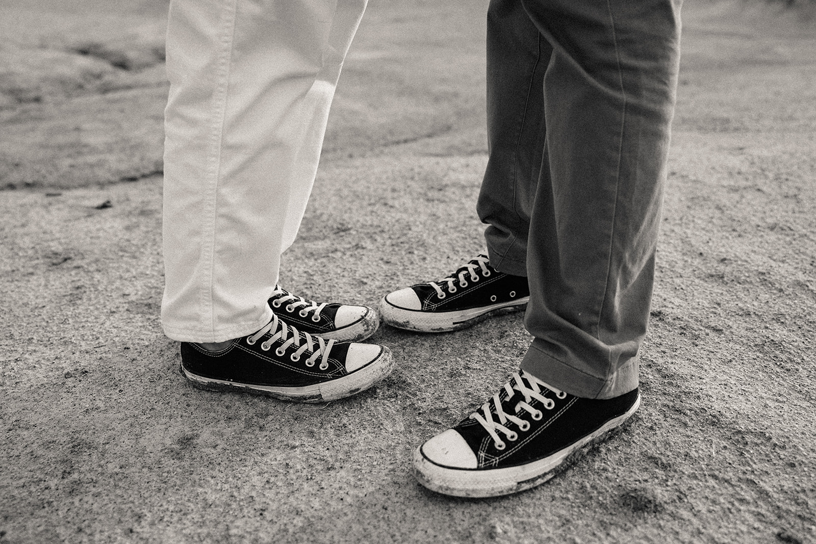 Close up to showing a woman and man wearing long pants and convers