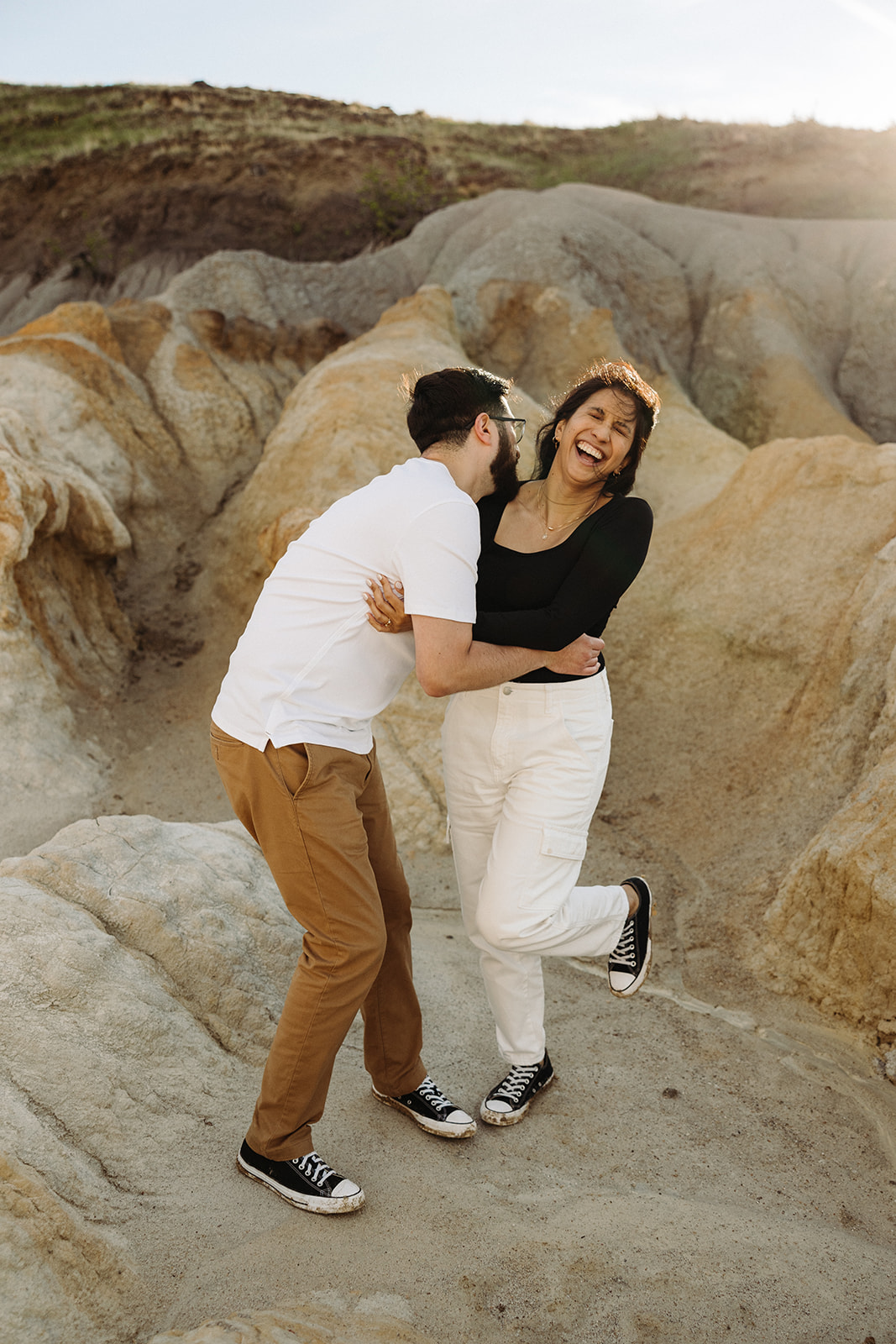 Man and woman laughing during their Mountain Engagement 