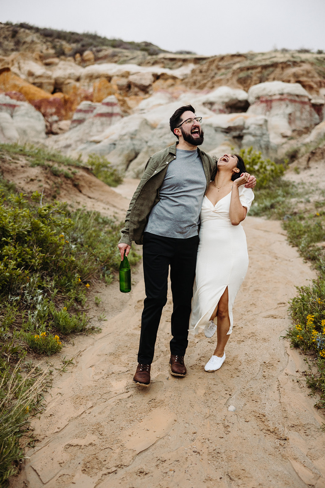 Man and woman laughing on a hike in the Colorado Mountians during their Mountain Engagement 