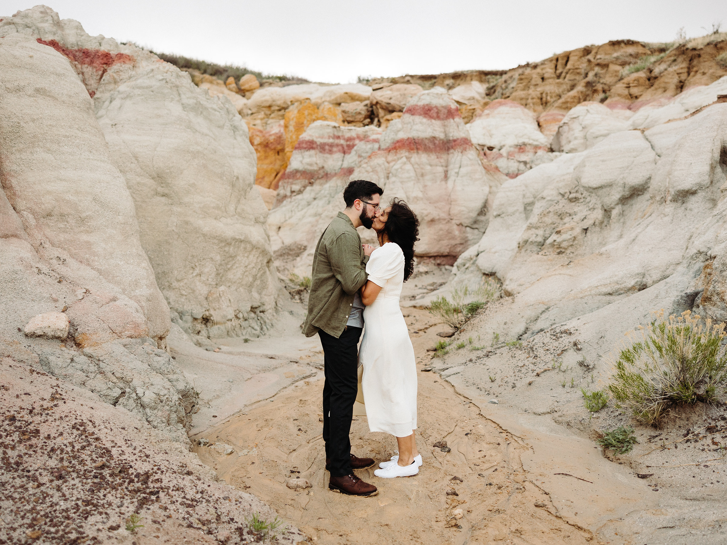 Man and woman kissing during their Mountain Engagement 