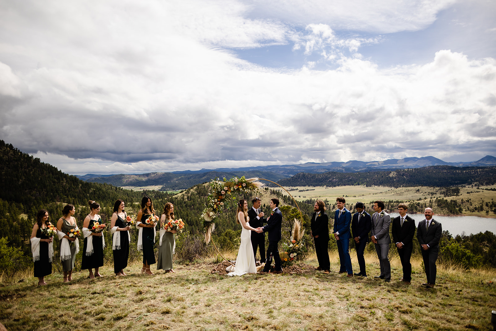 A couple with have their wedding ceremony in Florissant Colorado with mountains in the background.