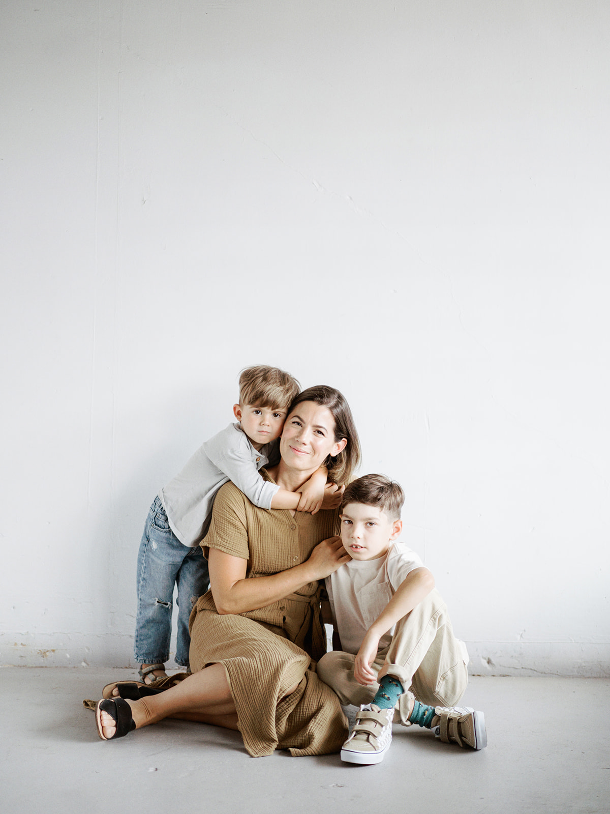 Mom and sons pose in the photography studio in Fort Payne, Alabama with Kelsey Dawn Photography