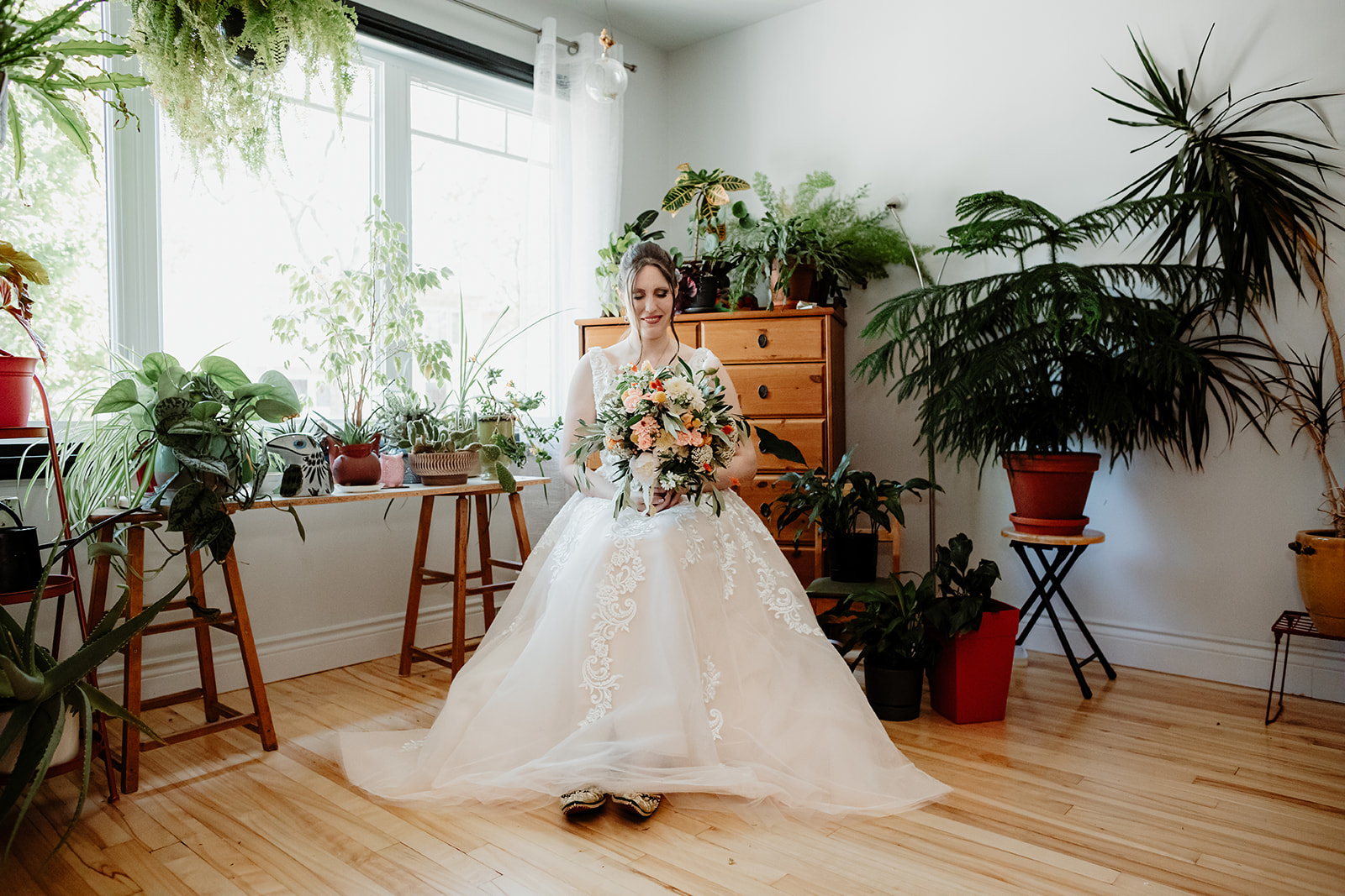 Bride getting ready at home surrounded by family and plants