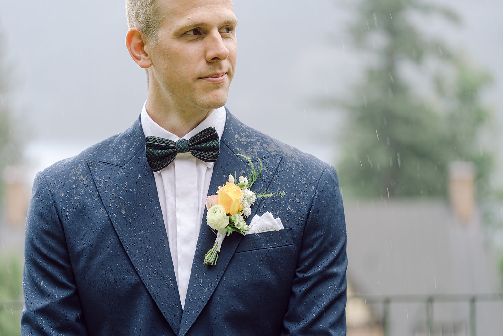 Groom's Senszio suit withstands a rain downpour during their Blaylock Mansion wedding in Nelson BC