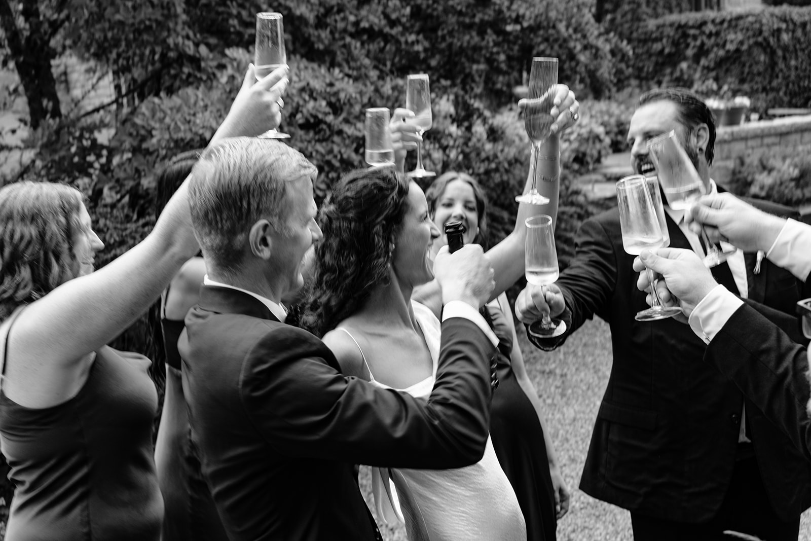 Wedding party celebrates with champagne at their Blaylock Mansion wedding in Nelson BC