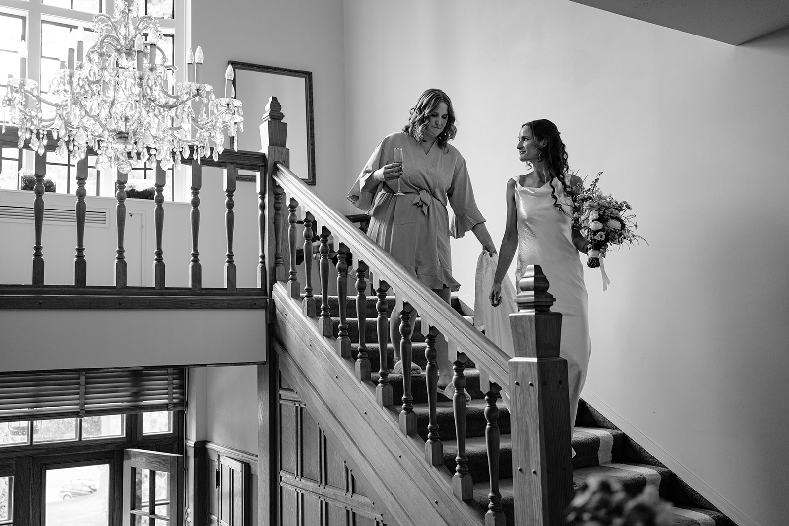 Bride descends stairs en route to her first look with her groom at her Blaylock Mansion wedding in Nelson BC