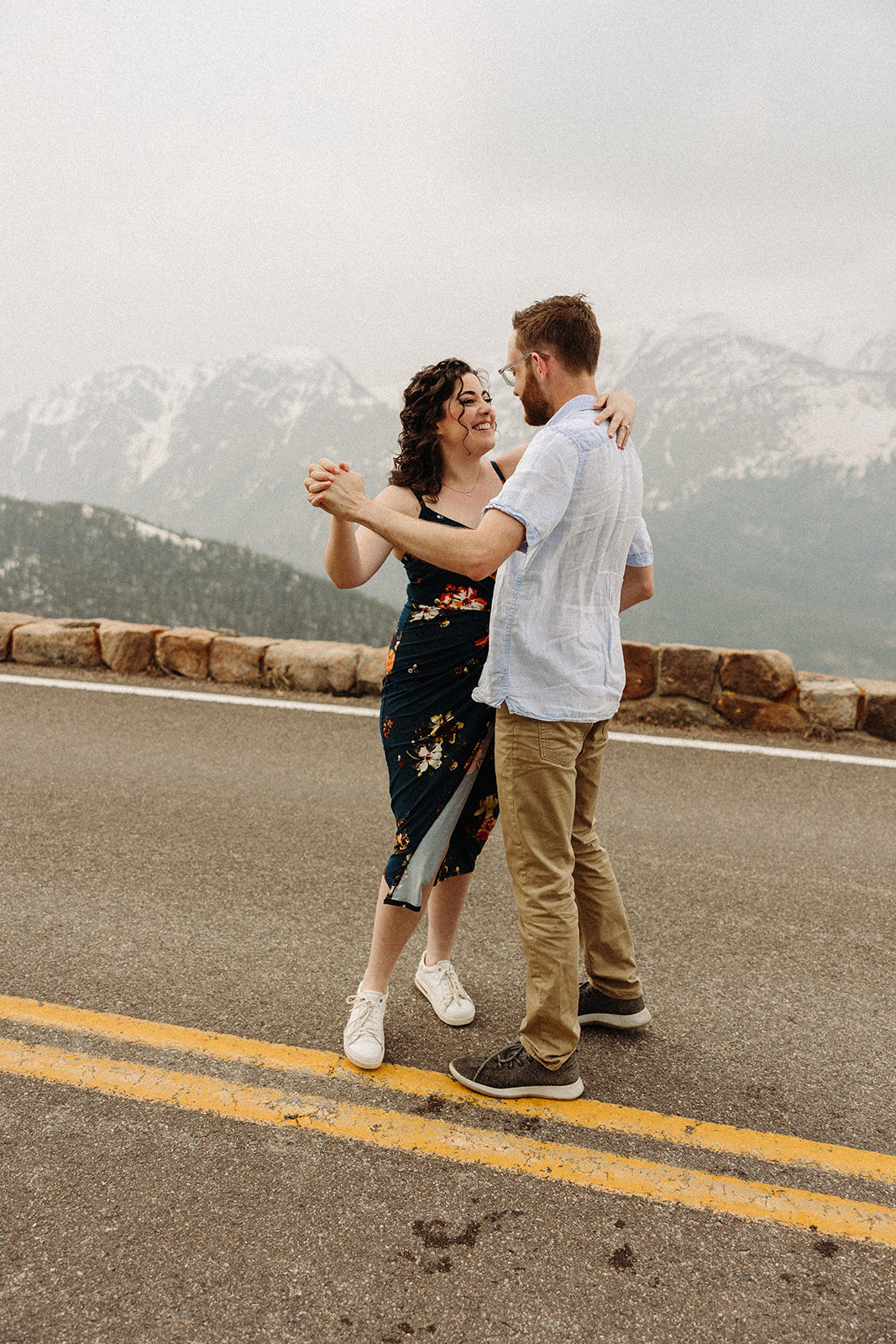 A man and a woman dancing on a road 