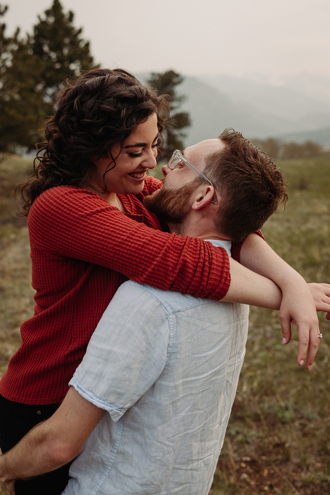 Man and woman kissing during their spring engagement photos