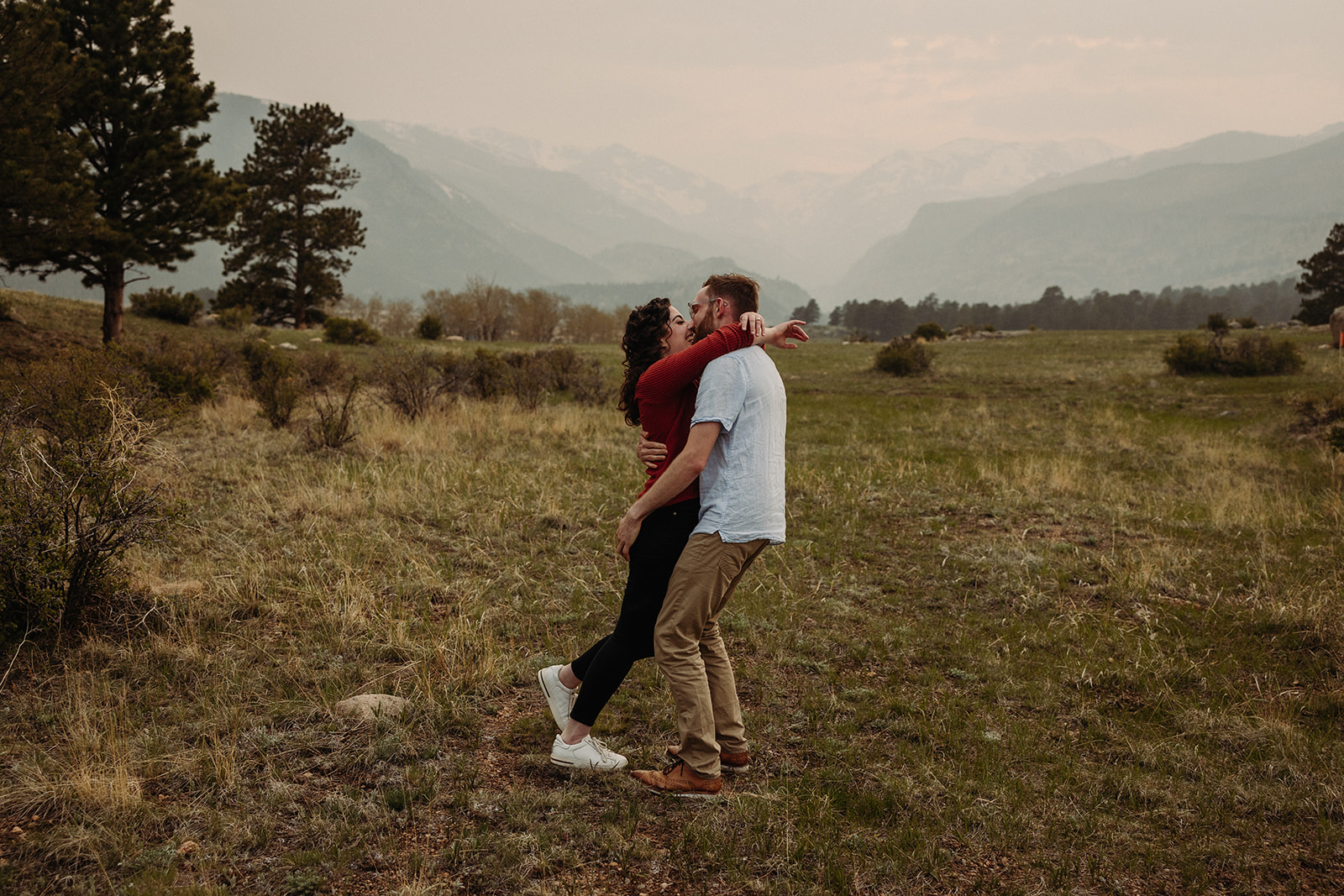 Man and woman kissing during their spring engagement photos