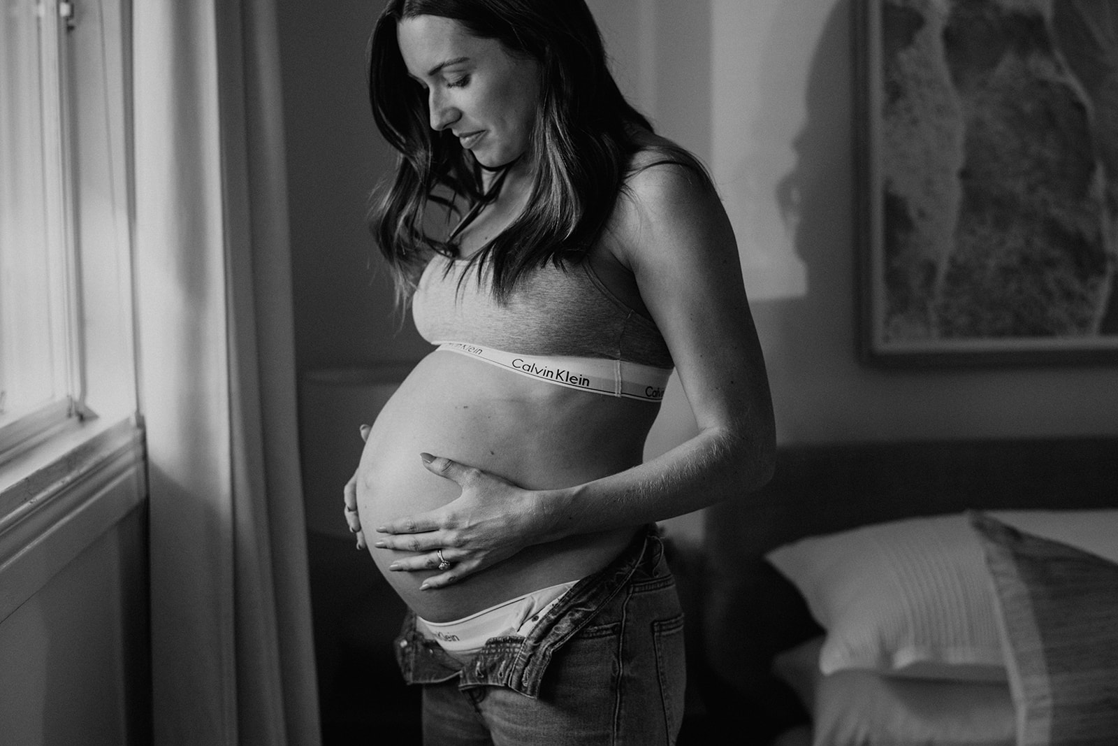 Black and white maternity photo taken in a relaxed Calvin Klein two-piece 