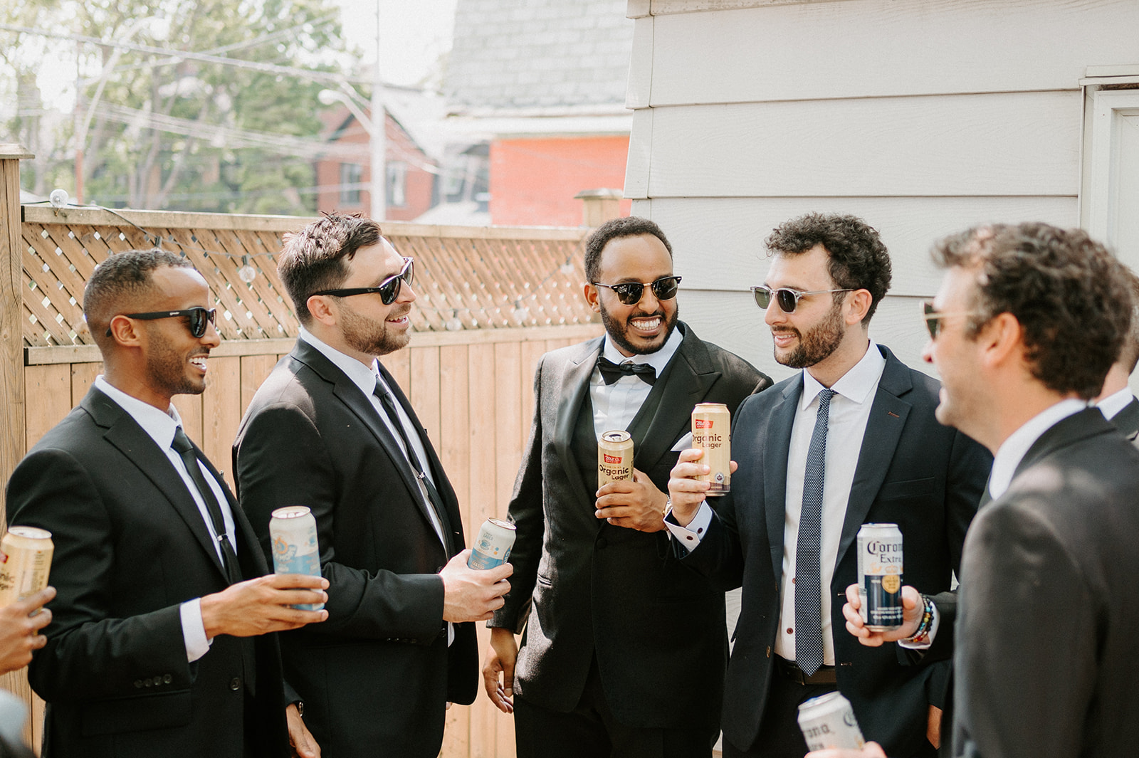 Groom drinking with groomsmen.