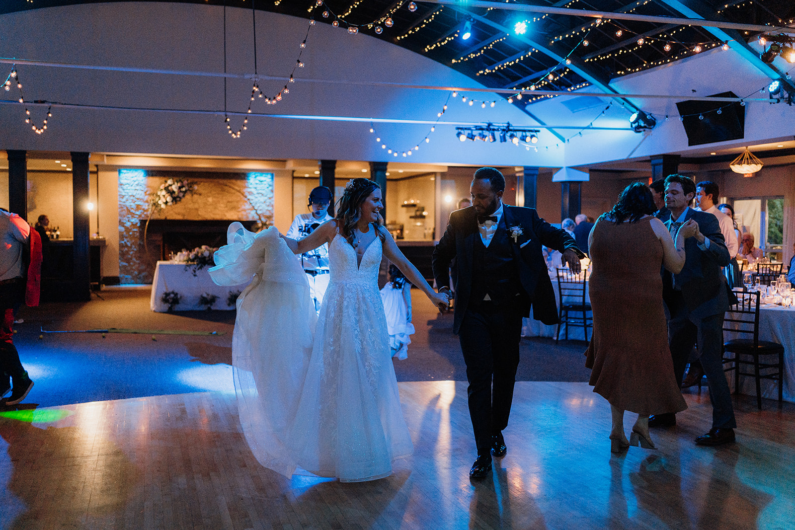 Husband and wife walking onto the dance floor.