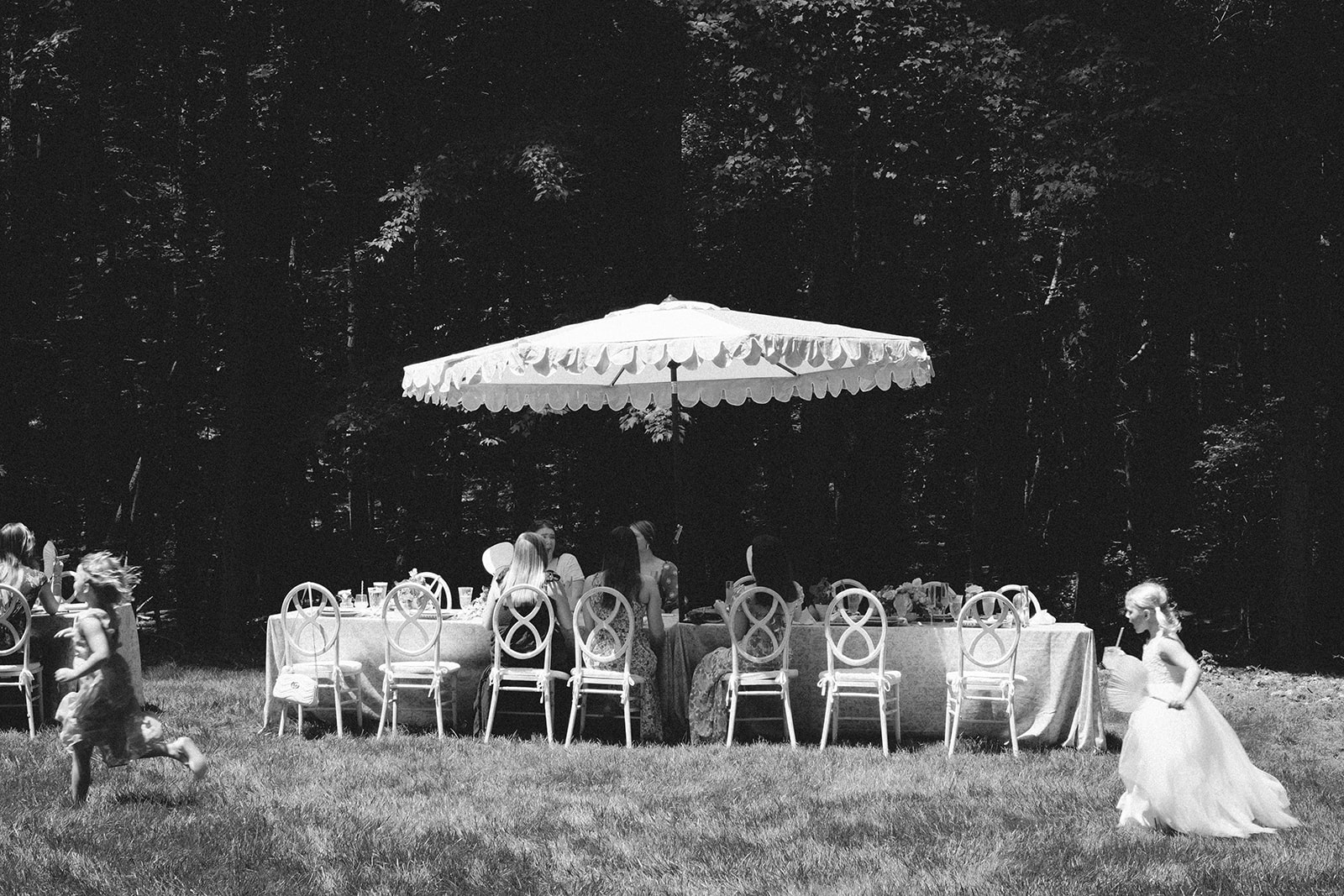 guests enjoying garden soiree baby shower black and white film image