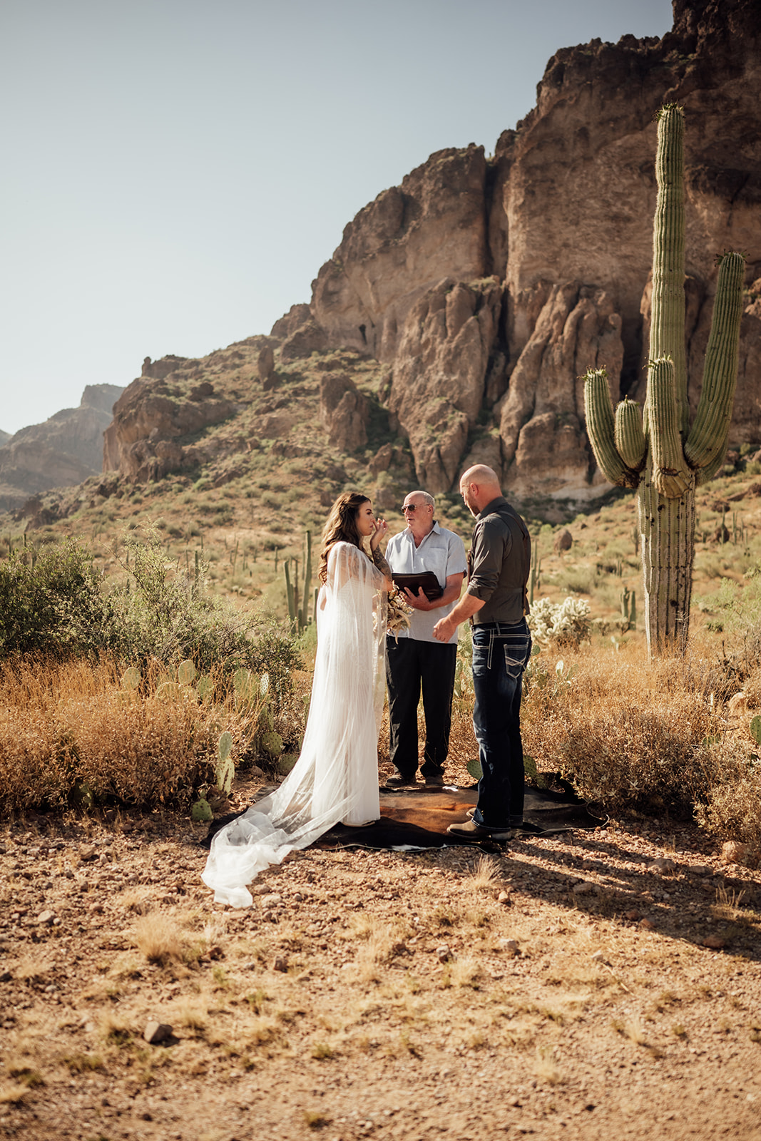 wedding ceremony with Superstition Mountains and saguaro cactus behind