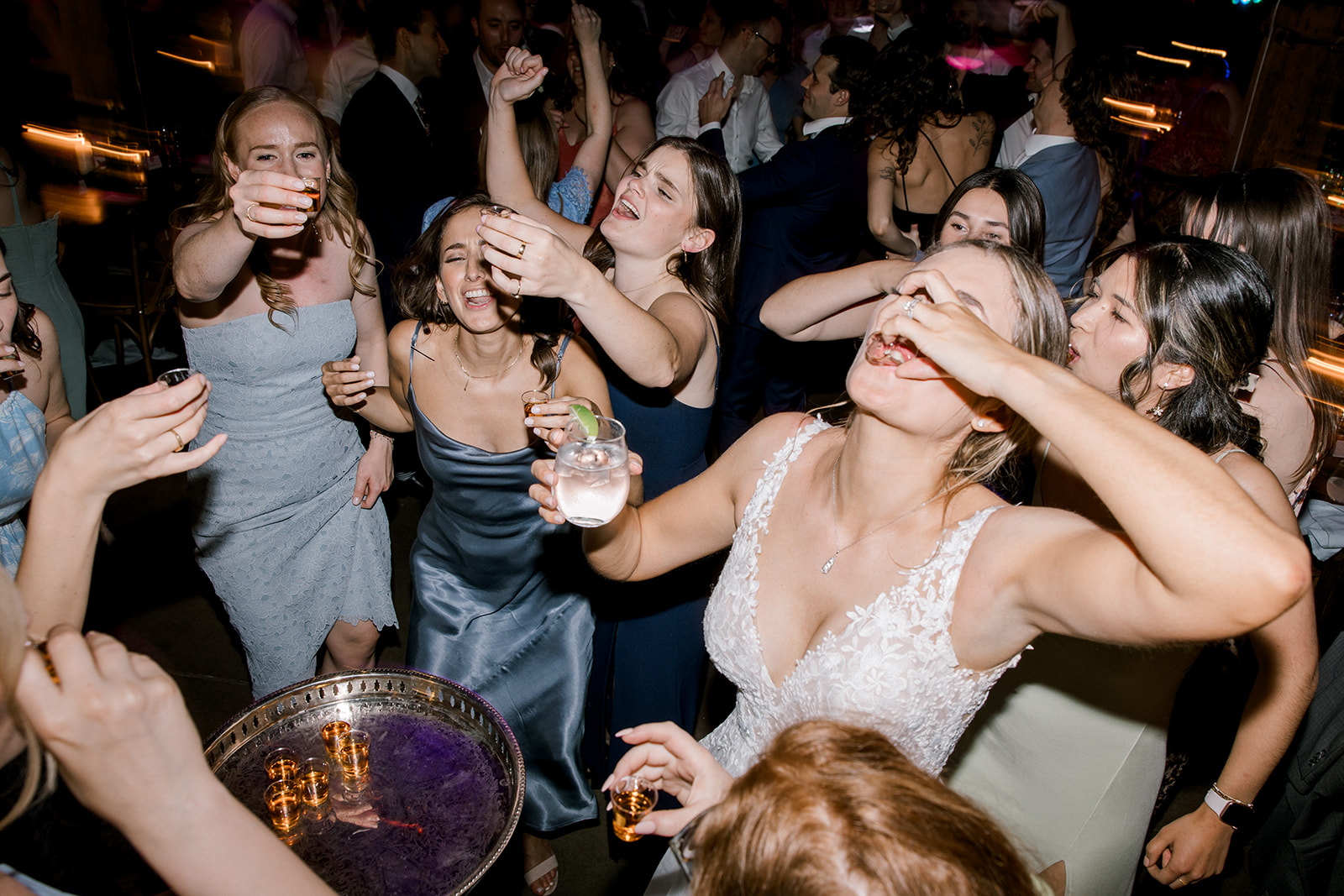 Bridal party takes shots during wedding reception at Steam Whistle Brewing in Toronto, Ontario