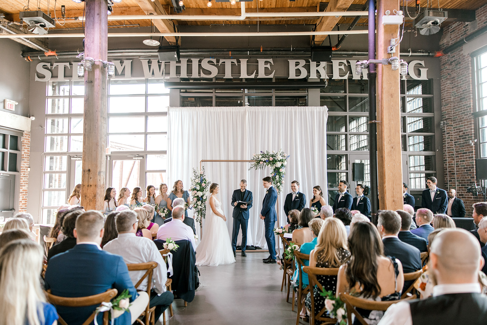 Couple stands during ceremony at Steam Whistle Brewing, Pilsner Hall in Toronto, Ontario