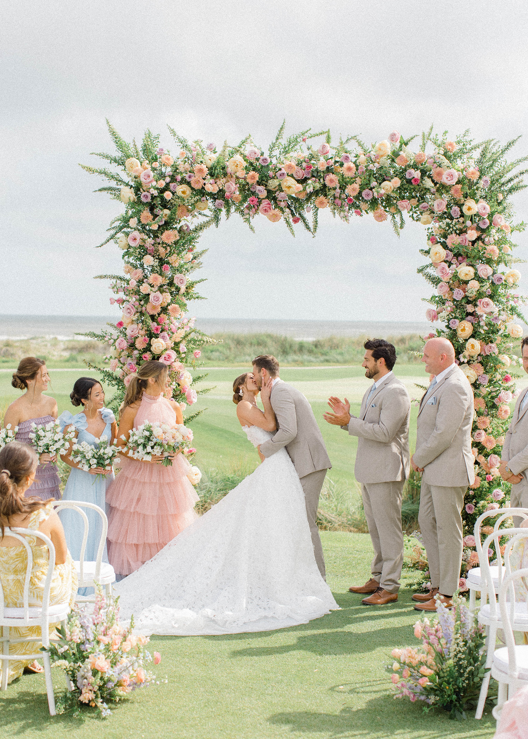 couple shares a kiss at The Ocean Course wedding in Kiawah Island