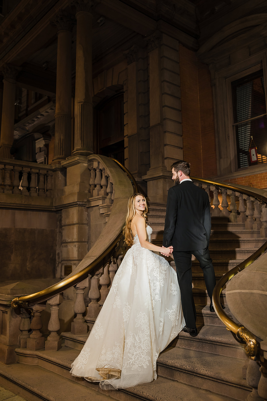 Nighttime wedding photo of the bride and groom  in Philadelphia on the steps of the Union League