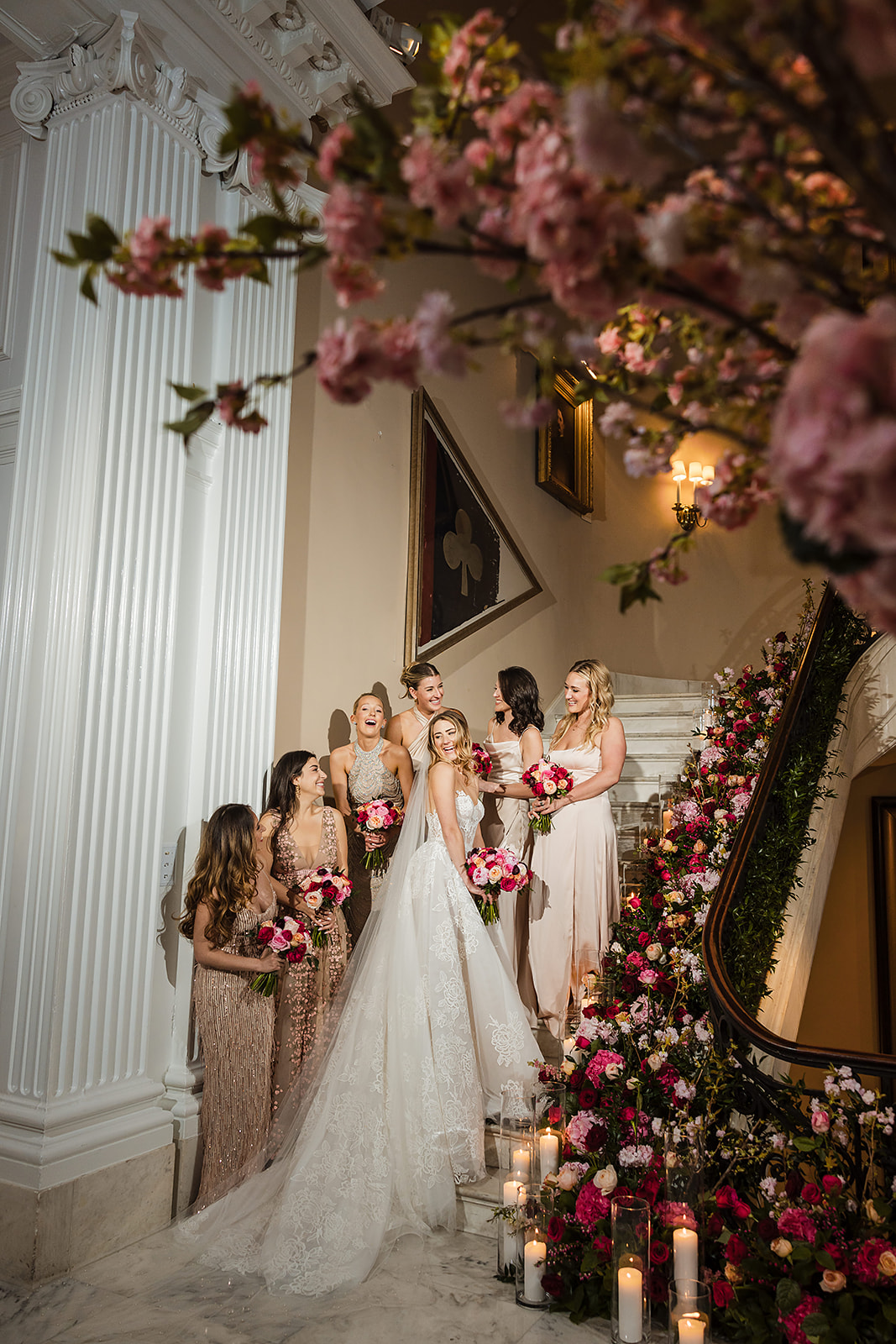 Wedding photo of the bride and bridesmaids in the grand staircase at the Union League in Philadelphia