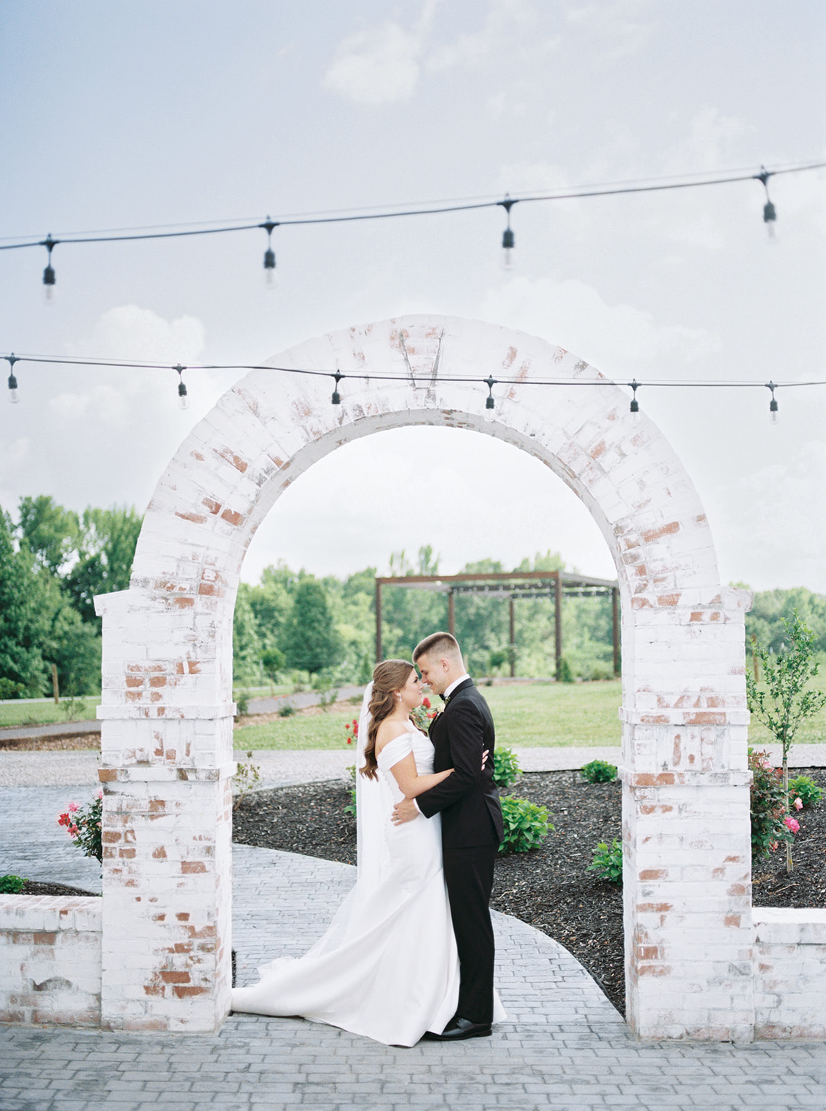 Bride and groom kiss under the arch at Blackberry Ridge in Trenton, Georgia