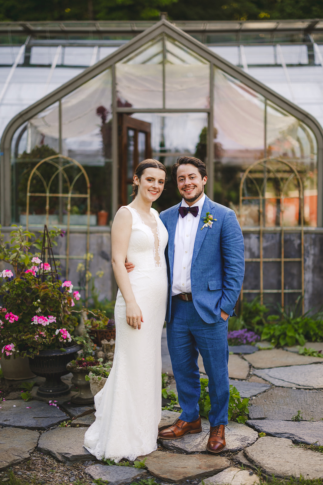 a bride and groom standing in front of the greenhouse  at Gloriosa & Co. Wedding, Ashfield, MA