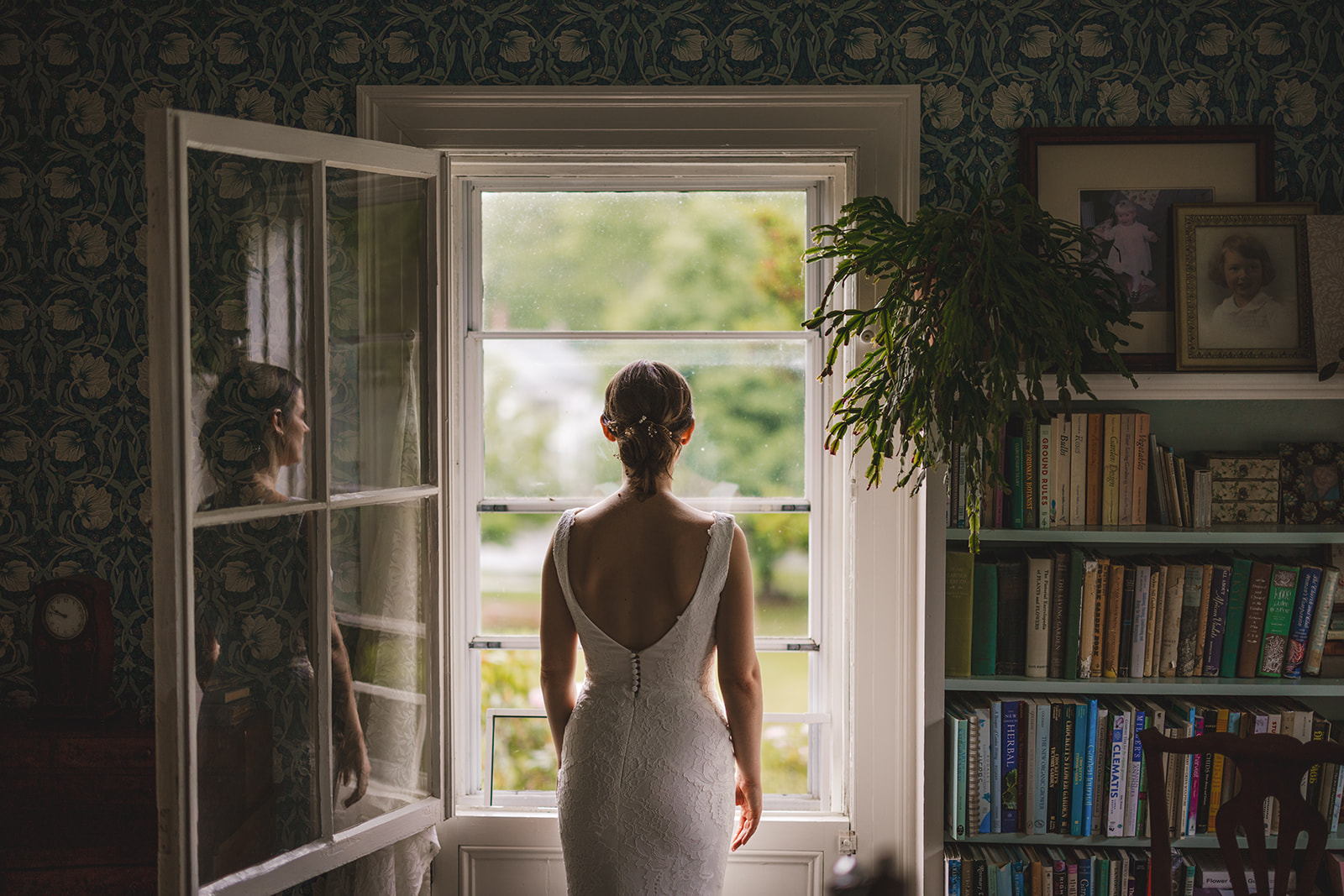 a bride looks out the window of an historic old home at Gloriosa & Co. in Ashfield, MA