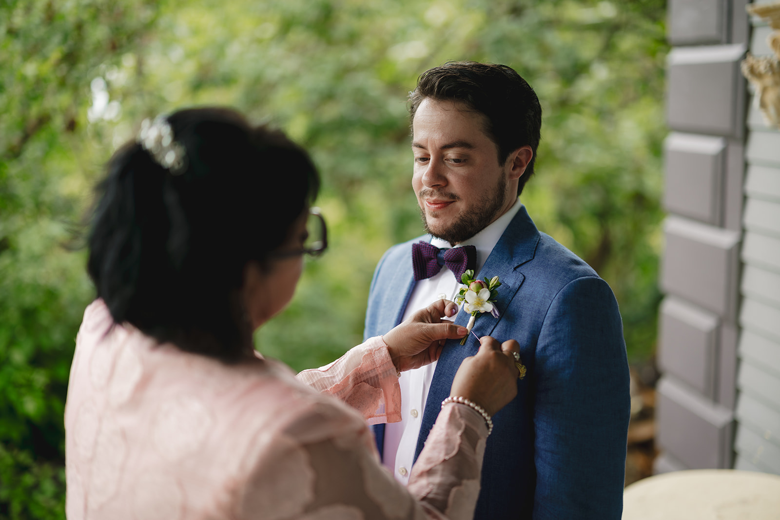 the mother of a groom fixes his boutonniere  at Gloriosa & Co. Wedding, Ashfield, MA