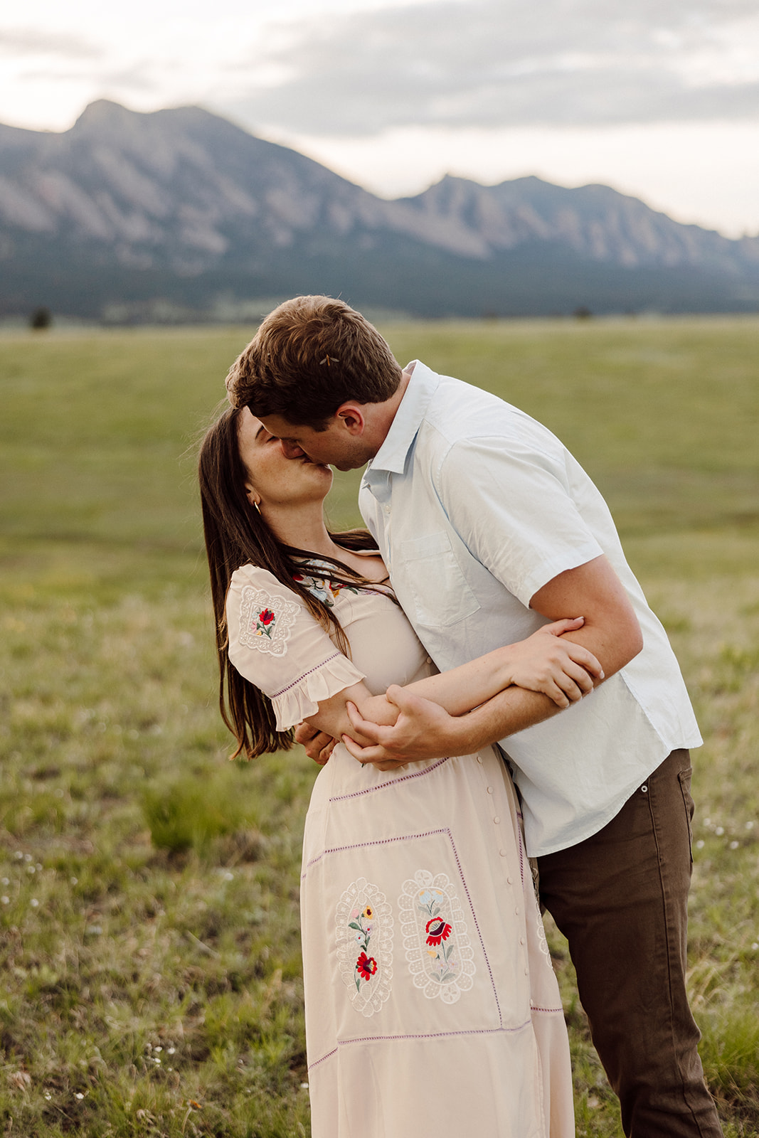 Denver couple kissing during the outdoor portion of their engagement photos with Mat Schramm