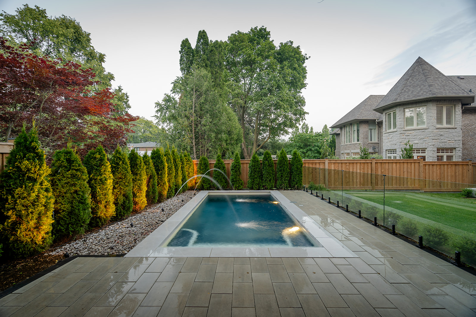An inground pool surrounded by patio.