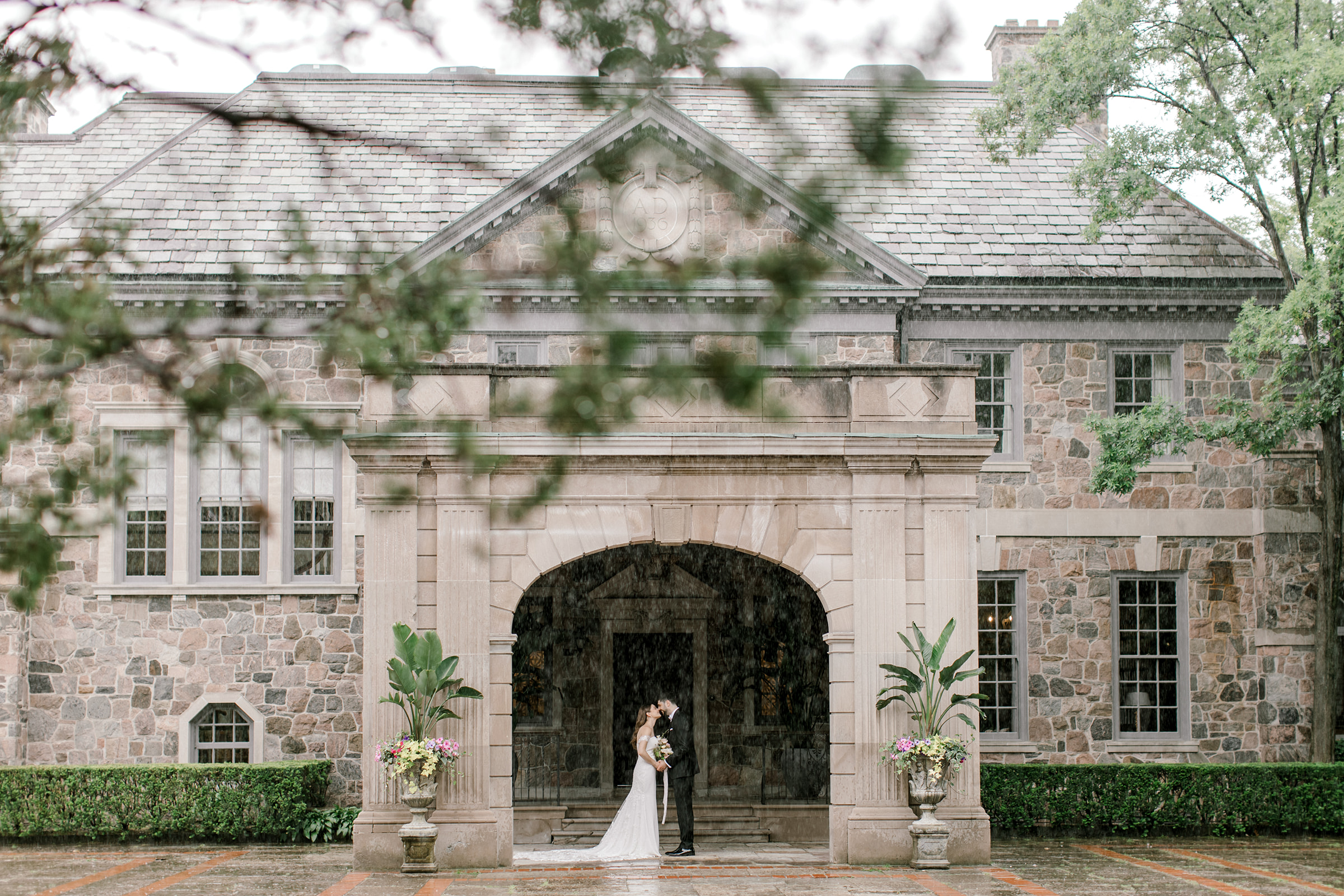 Couple kisses in the rain at their wedding at Graydon Hall Manor