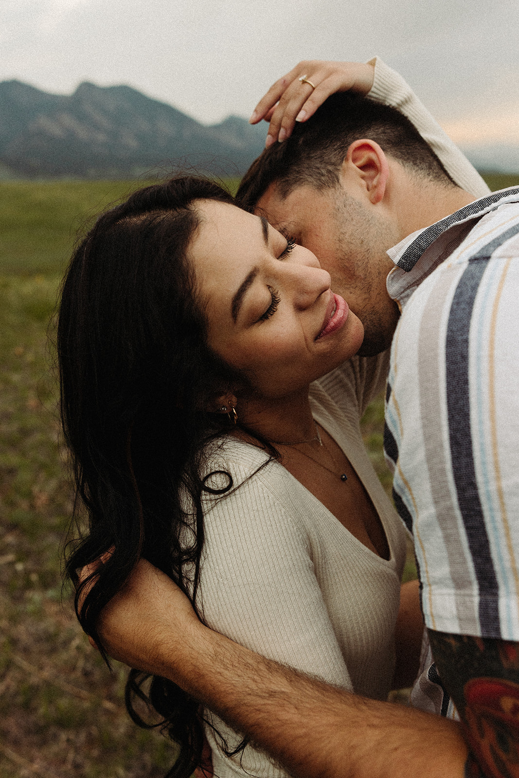 A man kissing a woman's neck