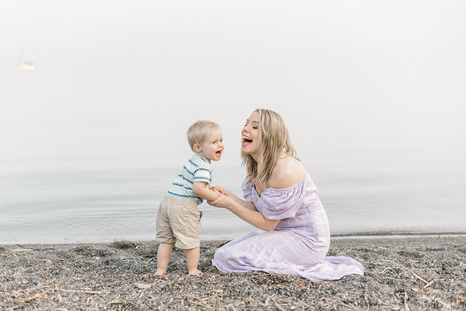 Mom and Son laugh on the beach during their family photoshoot