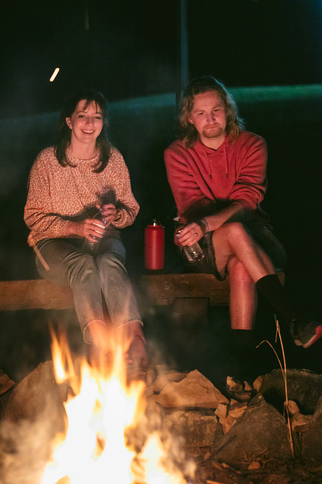 The couple enjoy a relaxing moment by the fire pit after all is said and done.