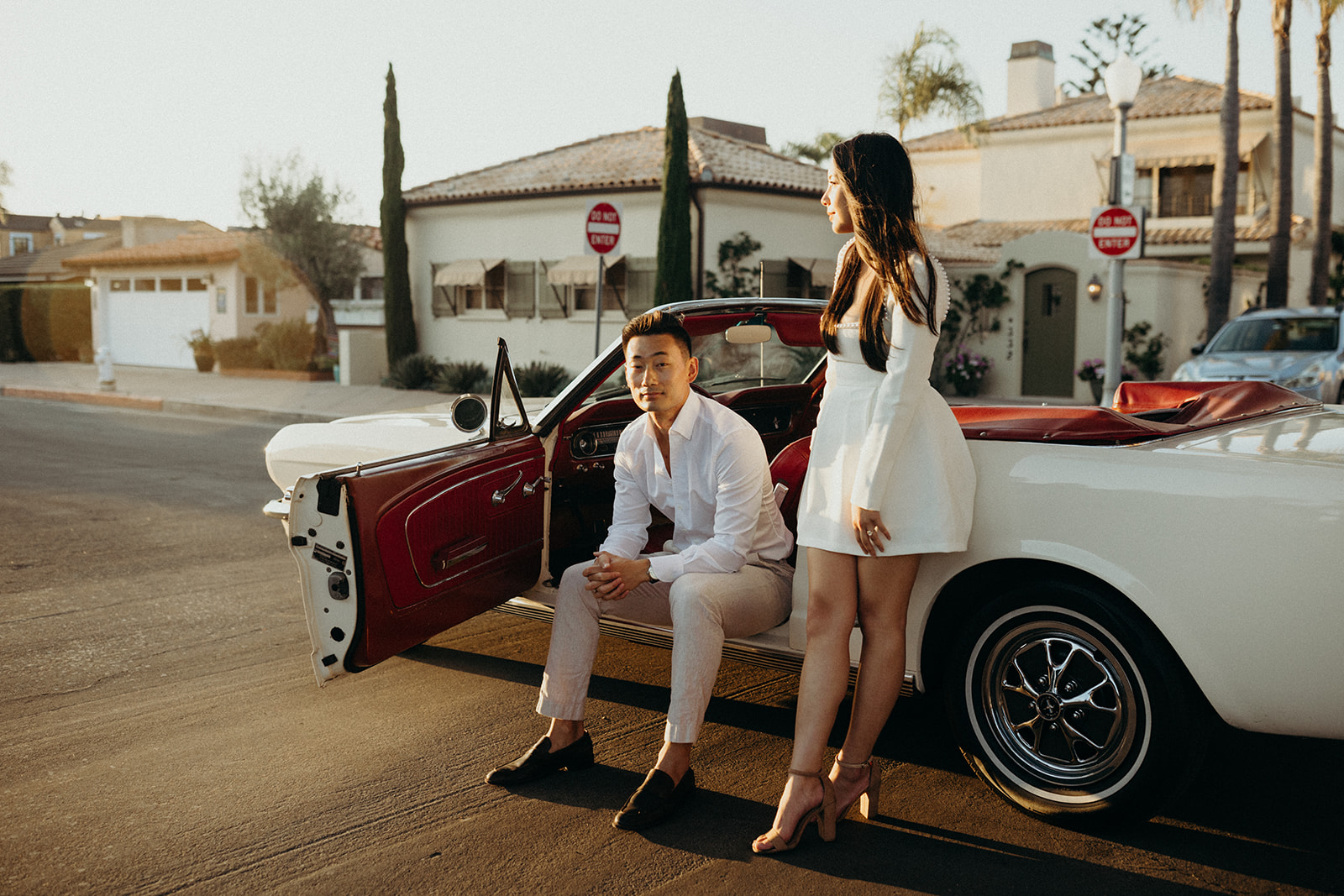 editorial style engagement session with a white vintage mustang