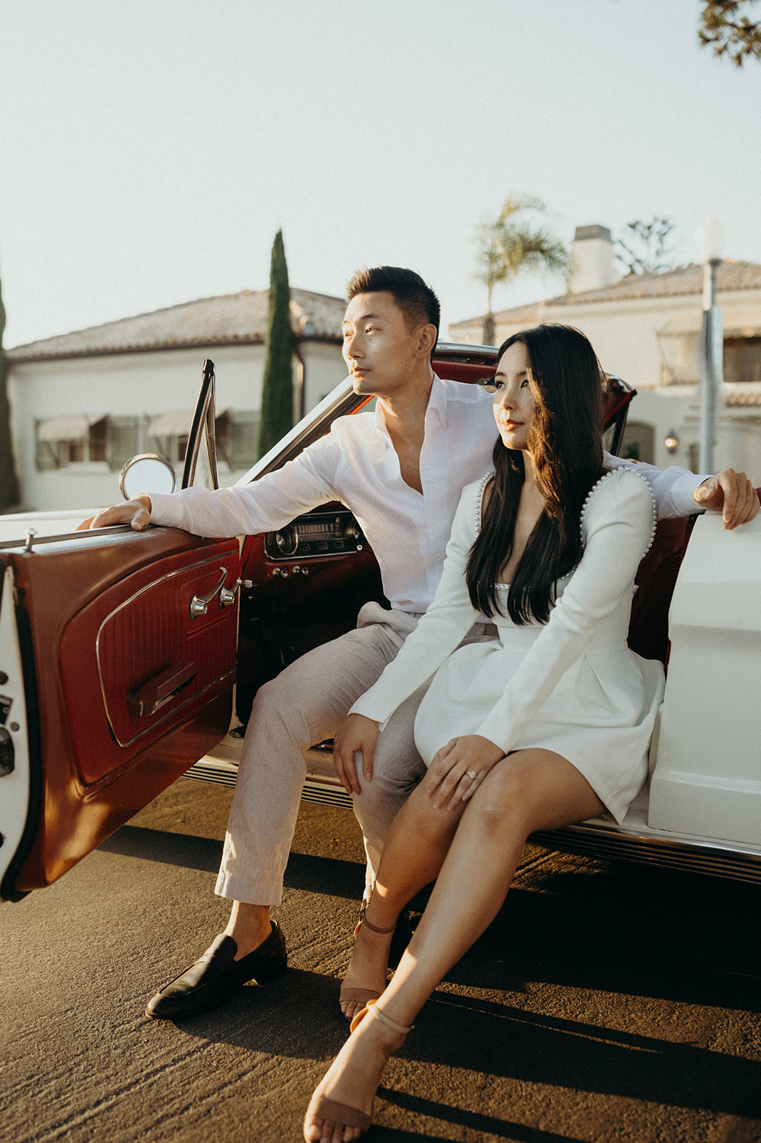editorial style orange county engagement session with a white vintage mustang
