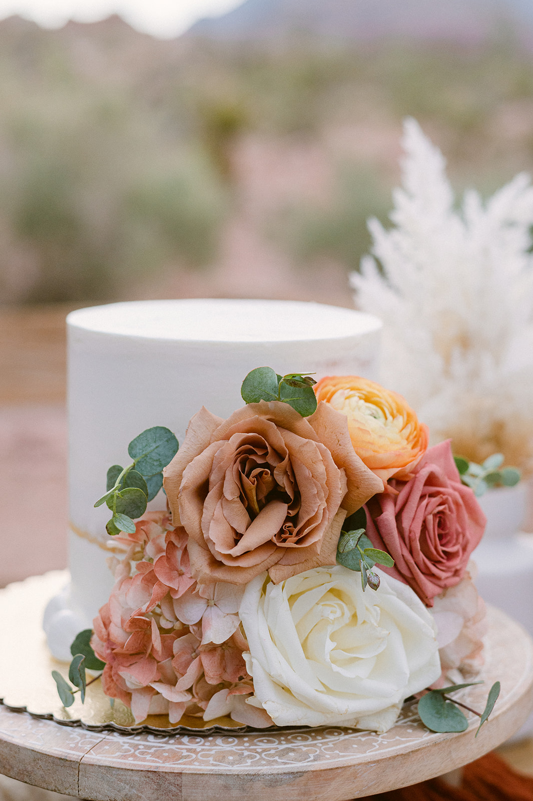 peach, yellow and blush floral on small white wedding cake