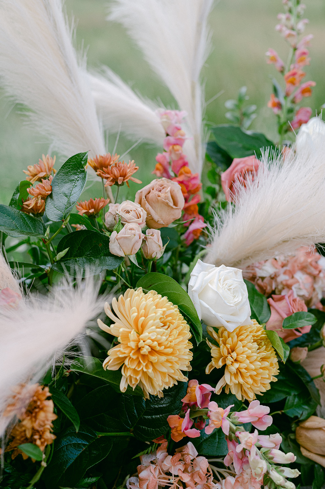 peach, yellow and blush wedding florals with pampas grass and hints of greenery