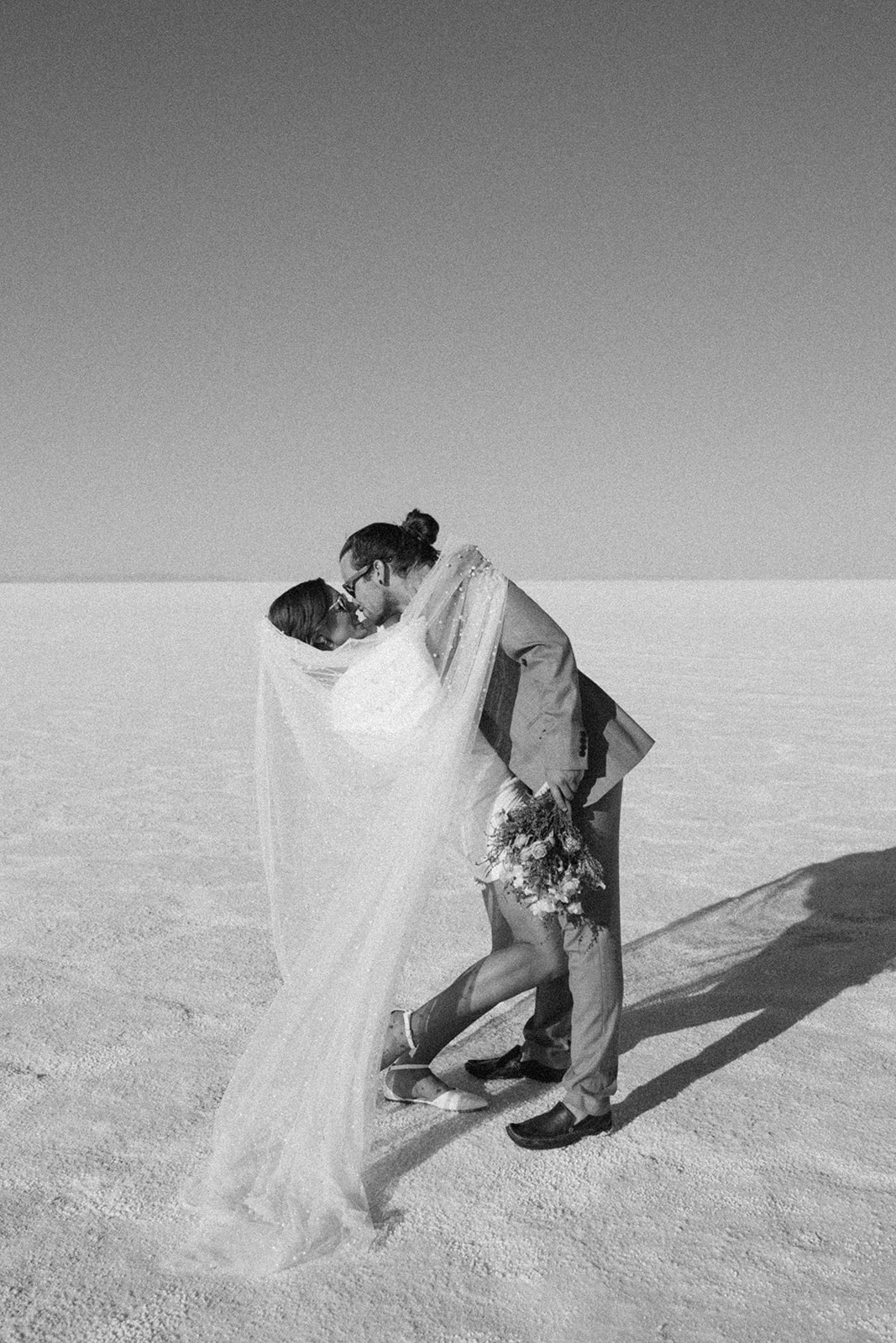couple embraces at salt flats elopement