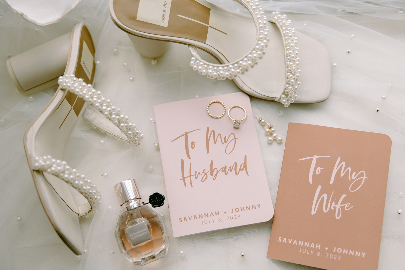 Classy wedding details with pink invitations, pearl shoes and pearl veil.