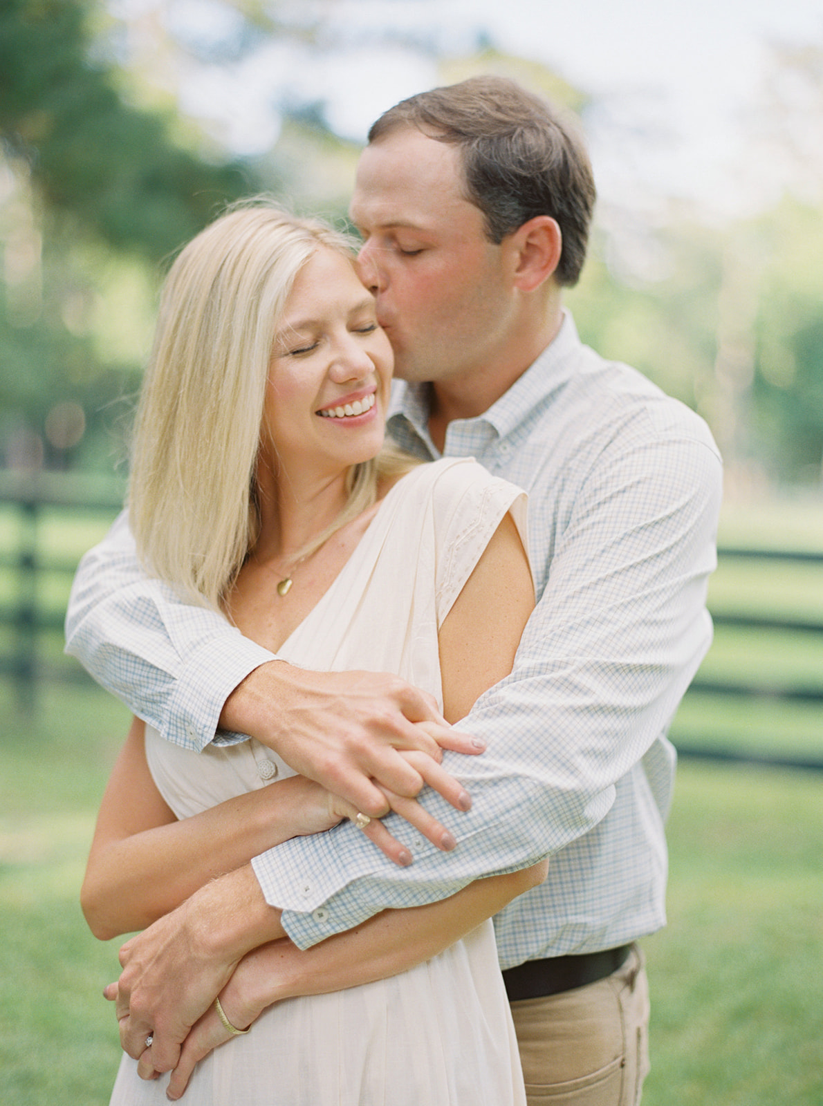 Engagement Session couple kissing on forehead during golden hour in Thomasville, Georgia. Film using Contax645
