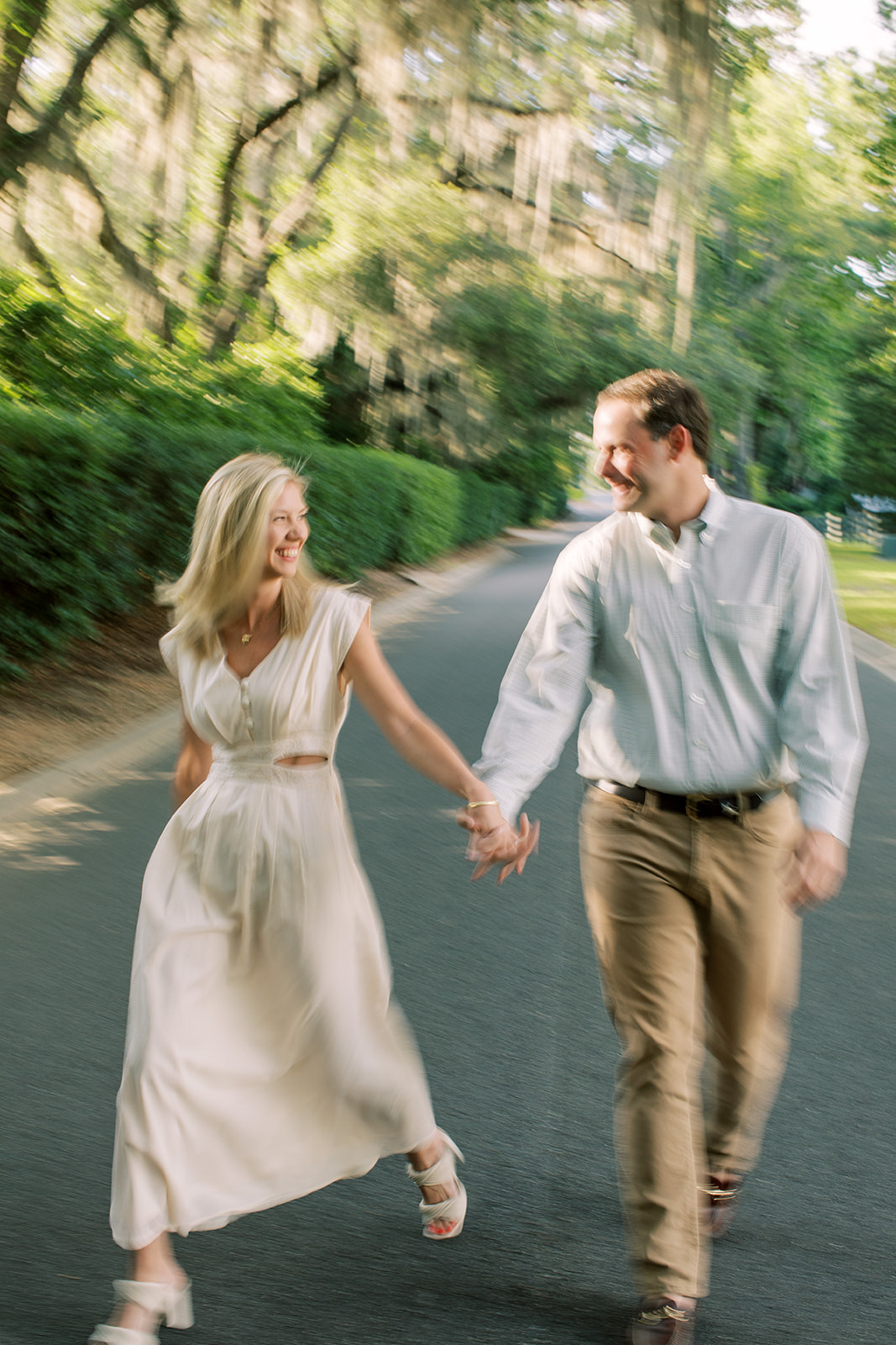 Engagement Session couple walking on street  during golden hour. Motion blur photography