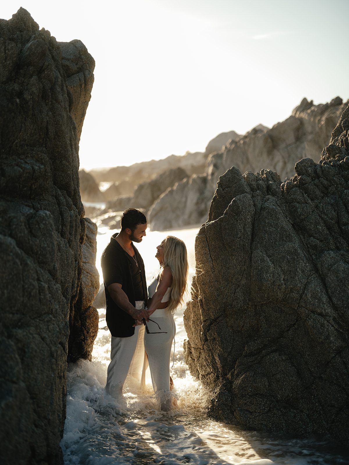 couple's photos on rock bluffs while tide comes in mexico