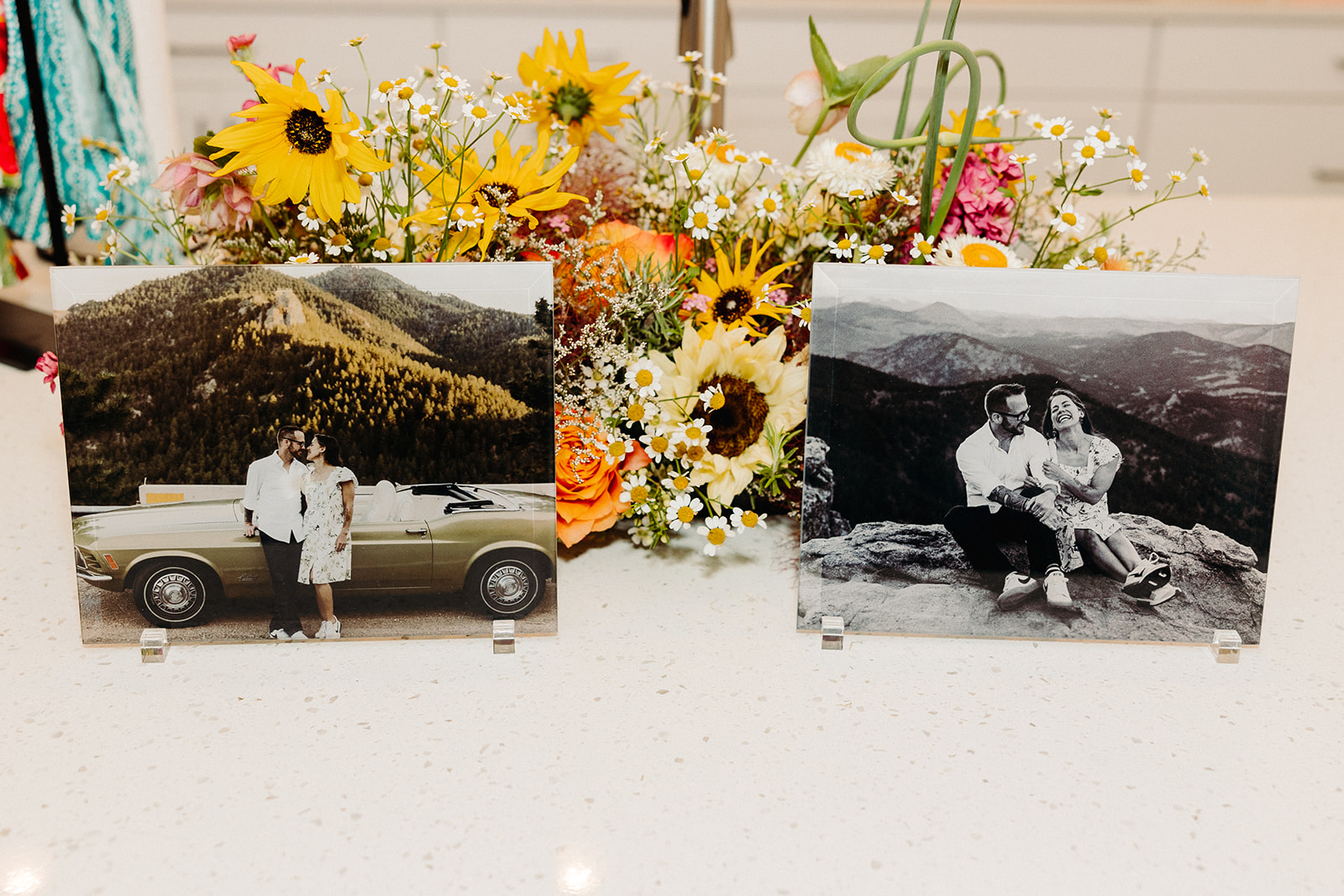Photos from Rolly and Veronica's elopement photo session with Mat Schramm Photography, on the counter w/ yellow flowers.