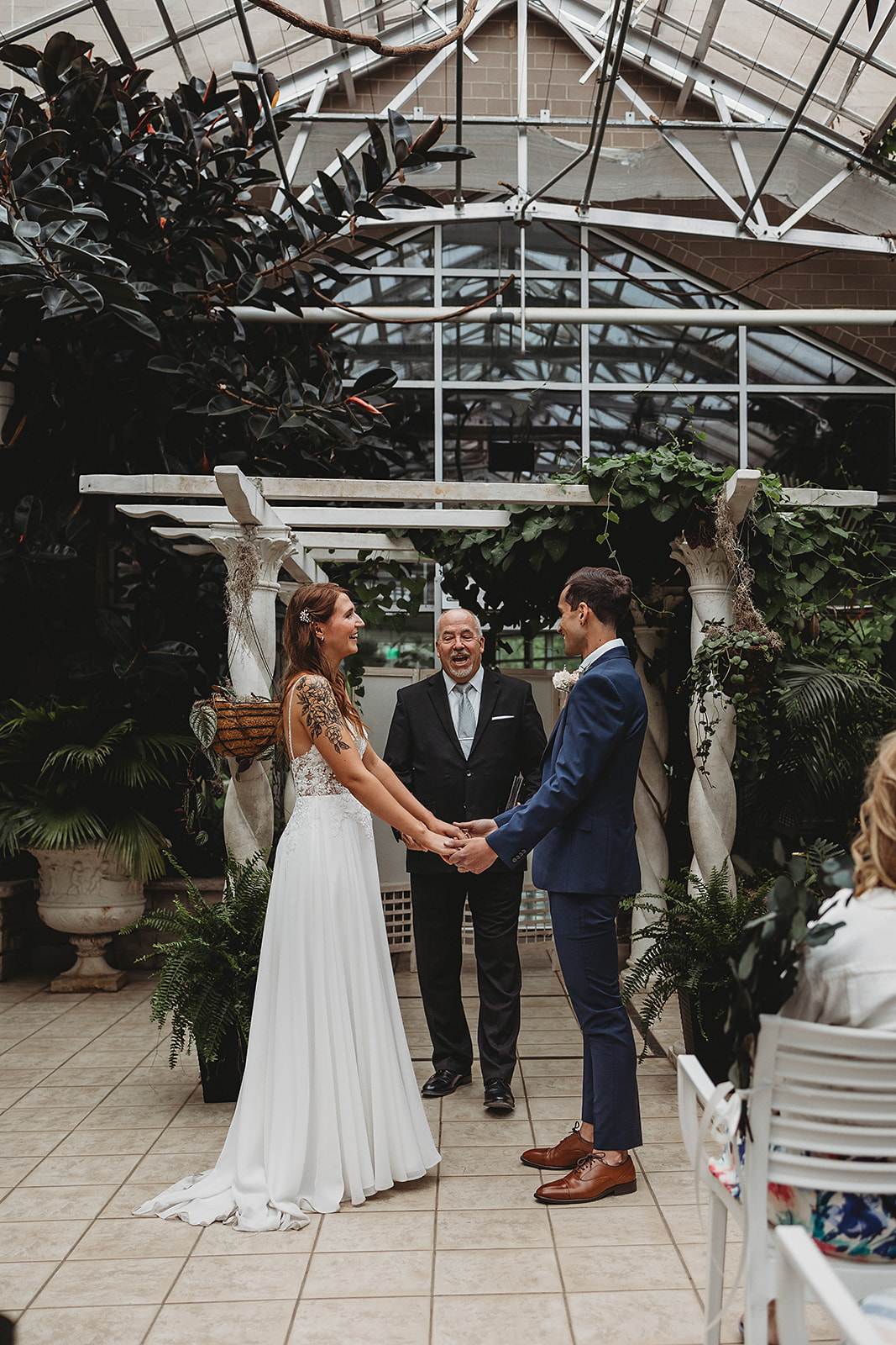 A couple who who married at Grand Rapids, Michigan say their vows in the Victorian Room of Frederik Meijer Gardens
