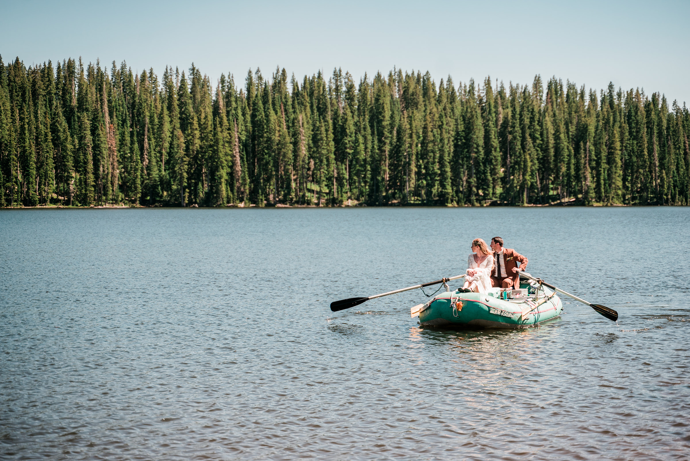 Bride and groom rafting on a lake | Kiser Creek Cabins Wedding