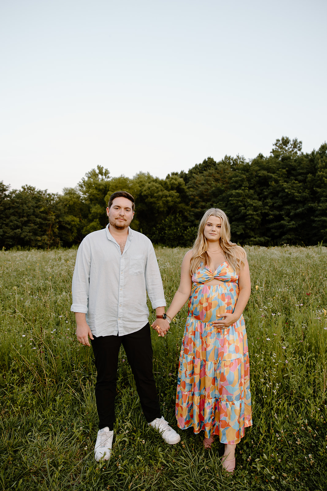 Wildflower field couples pregnancy announcement photos