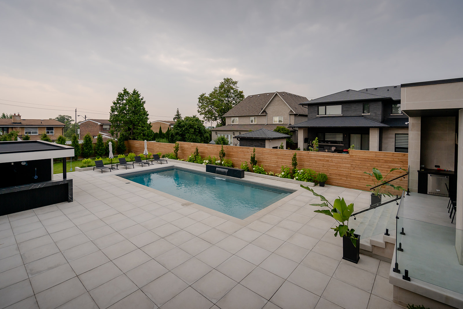 An inground pool surrounded by patio stones.