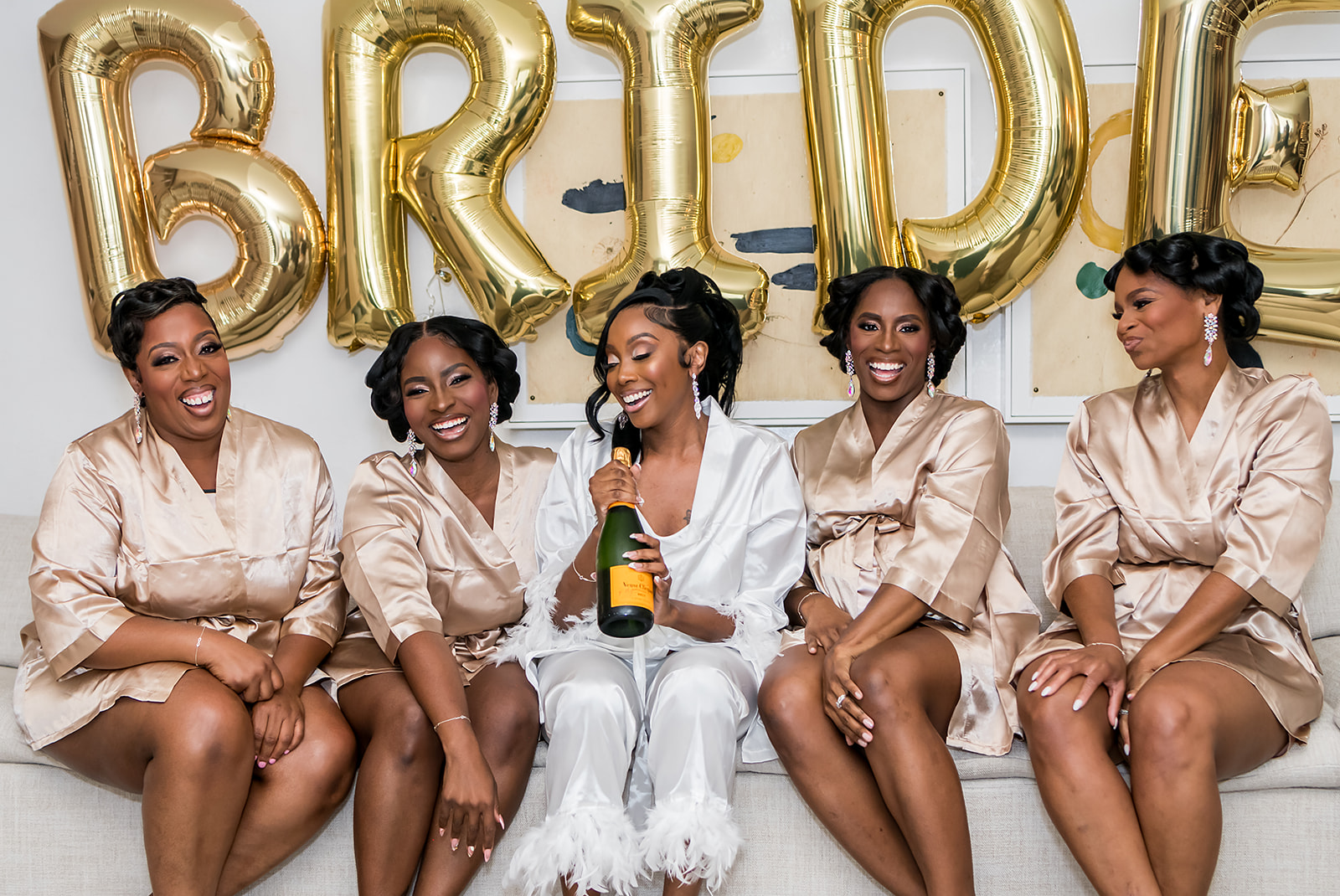 Bride Popping bottles on wedding day while getting ready at Kimpton Sylvan Hotel with JGraced Photography